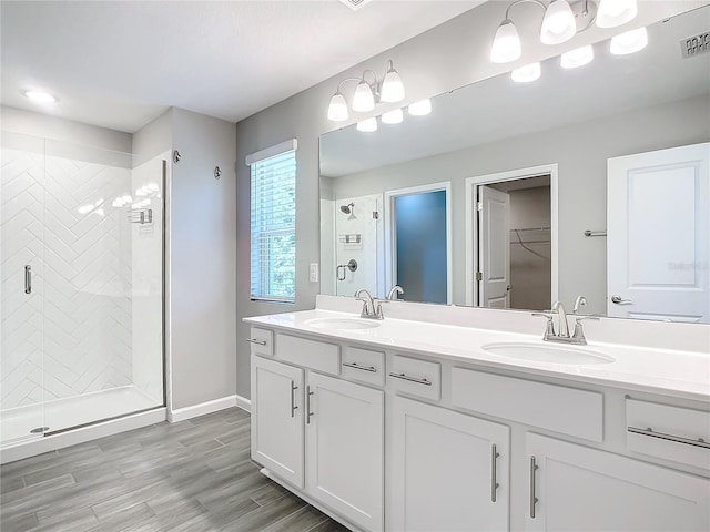 bathroom featuring vanity, hardwood / wood-style flooring, and a shower with shower door