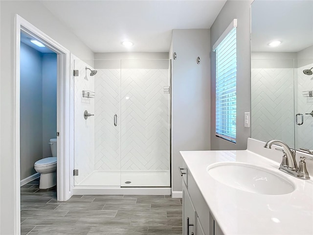 bathroom with vanity, toilet, and walk in shower