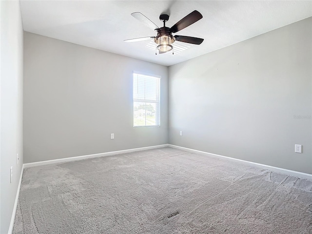 unfurnished room featuring ceiling fan and light colored carpet