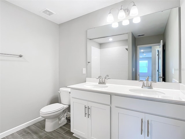 bathroom featuring vanity, toilet, and a shower