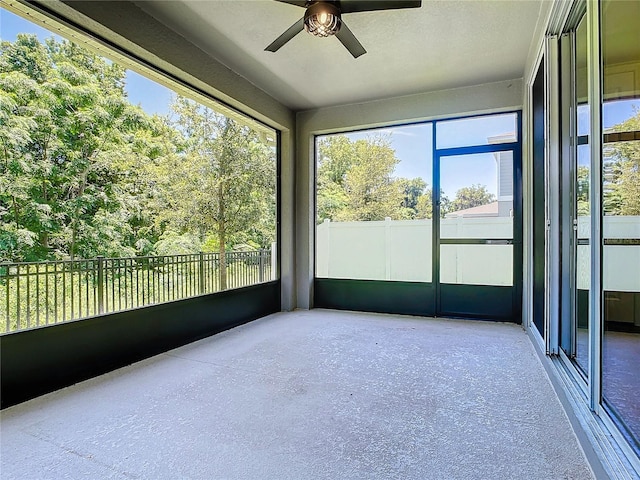 unfurnished sunroom featuring ceiling fan