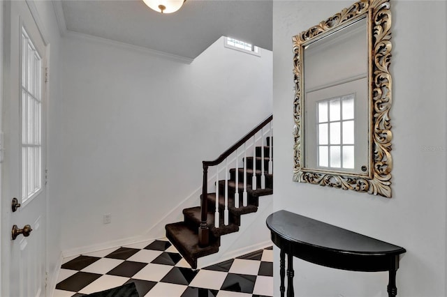 stairs featuring ornamental molding, baseboards, and tile patterned floors