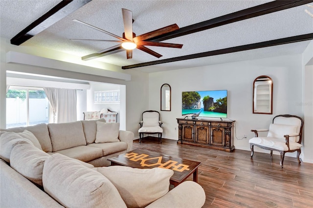 living room with a textured ceiling, beam ceiling, and wood finished floors