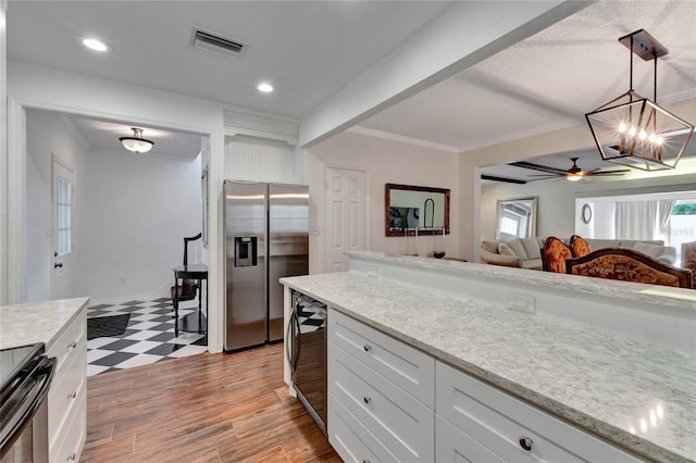 kitchen with visible vents, appliances with stainless steel finishes, white cabinets, and pendant lighting