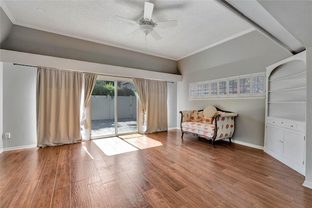 unfurnished room with ceiling fan, a textured ceiling, baseboards, and wood finished floors