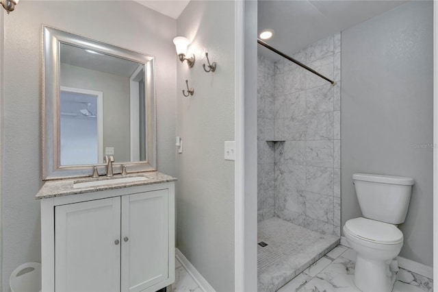 full bathroom with marble finish floor, a shower stall, baseboards, and vanity