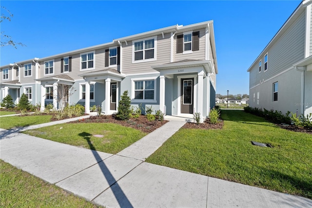 view of property with a residential view and a front lawn