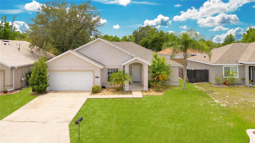 single story home with a garage and a front lawn