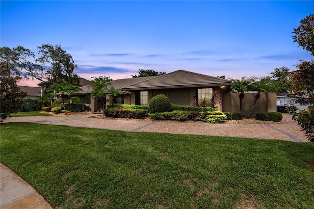 view of front of home with a lawn