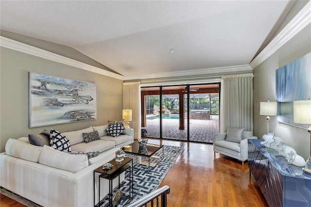 living room featuring vaulted ceiling, crown molding, and wood-type flooring