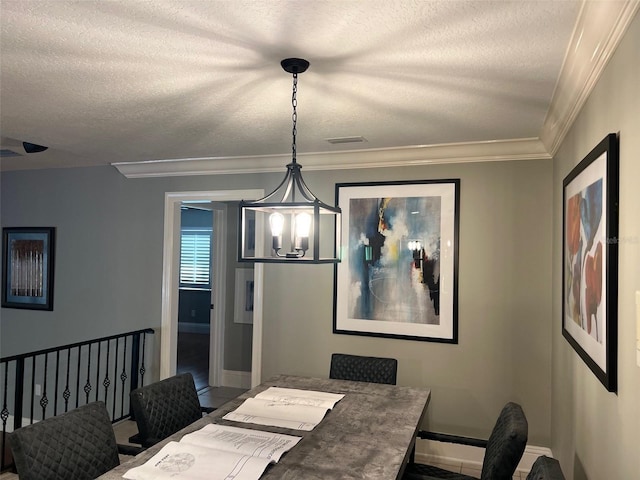 dining area with a textured ceiling, crown molding, and a notable chandelier