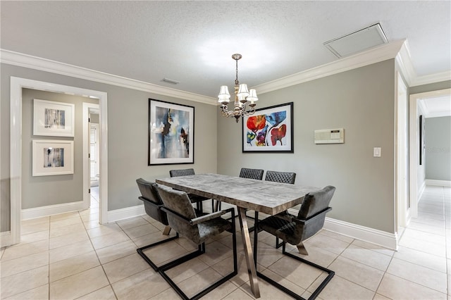 tiled dining space featuring a textured ceiling, ornamental molding, and a chandelier