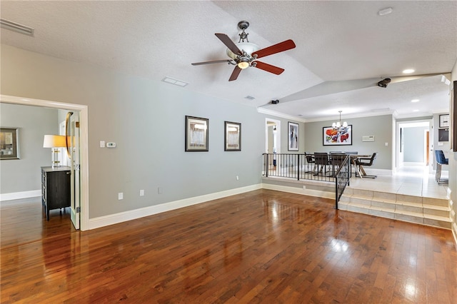 unfurnished living room featuring a textured ceiling, lofted ceiling, ceiling fan with notable chandelier, and wood-type flooring