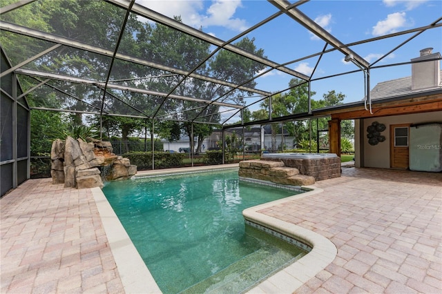 view of swimming pool with a lanai and a patio