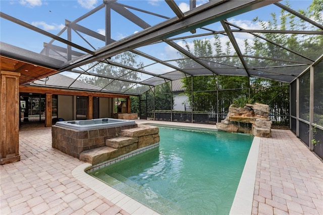 view of swimming pool featuring an in ground hot tub, a lanai, and a patio area