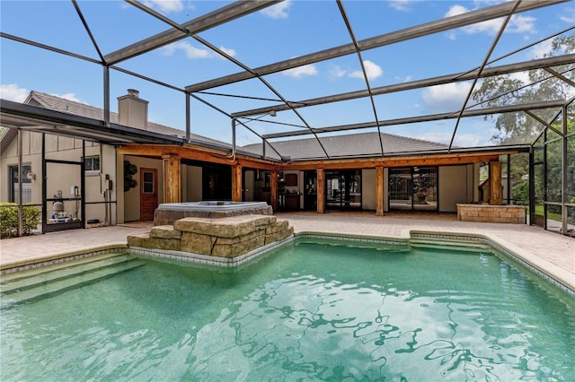 view of pool with a lanai, a hot tub, and a patio area