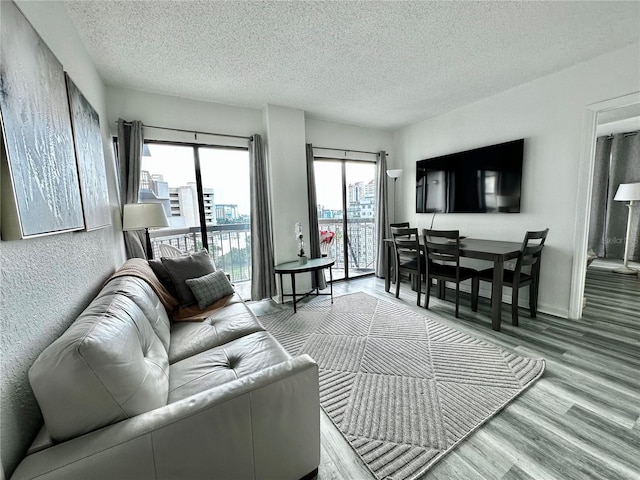 living room featuring hardwood / wood-style flooring, a wealth of natural light, and a textured ceiling