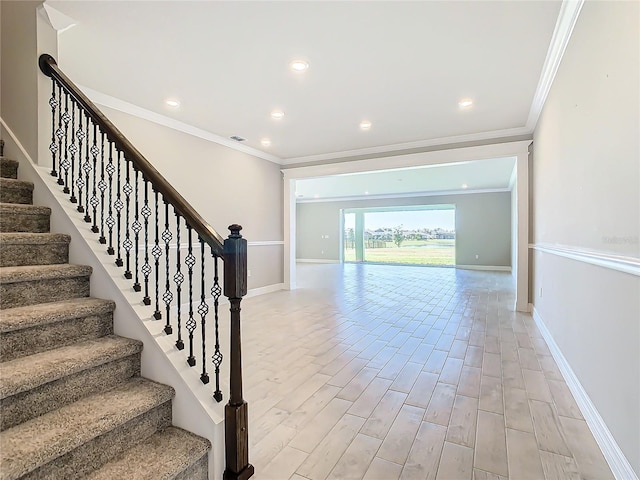 staircase featuring crown molding and wood-type flooring