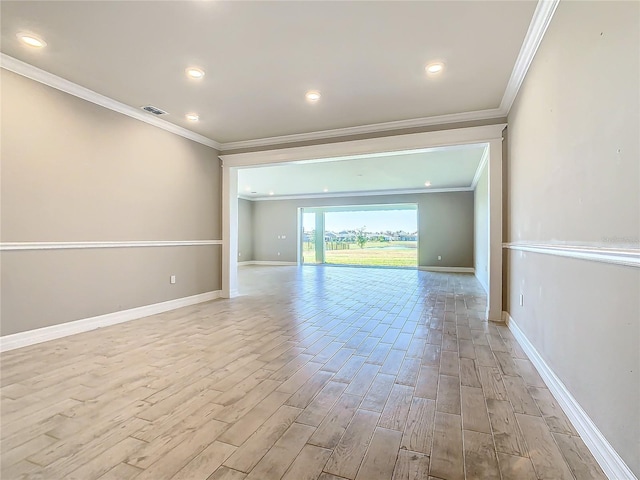 unfurnished room featuring crown molding and light hardwood / wood-style flooring