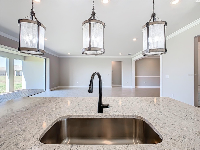 kitchen with ornamental molding, sink, and light stone counters