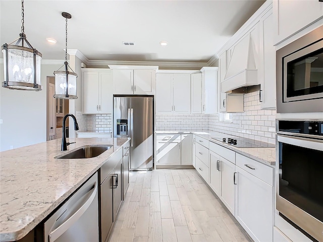 kitchen with white cabinetry, appliances with stainless steel finishes, and sink