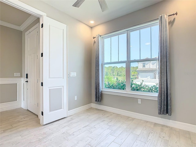 empty room with ceiling fan and light wood-type flooring