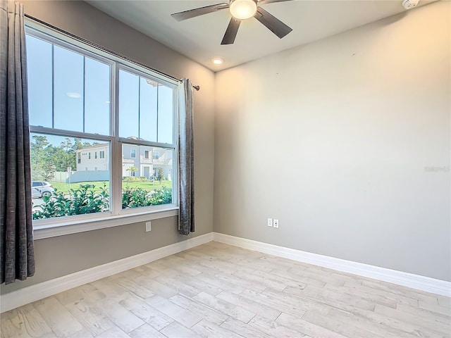 unfurnished room with ceiling fan and light wood-type flooring