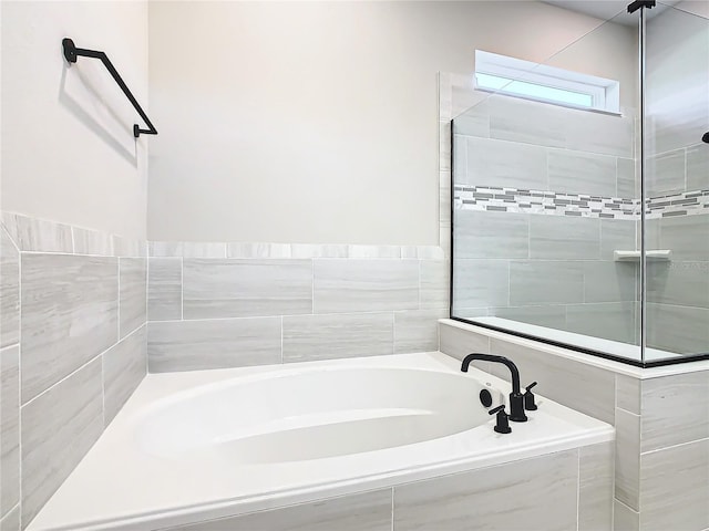 bathroom featuring tiled bath