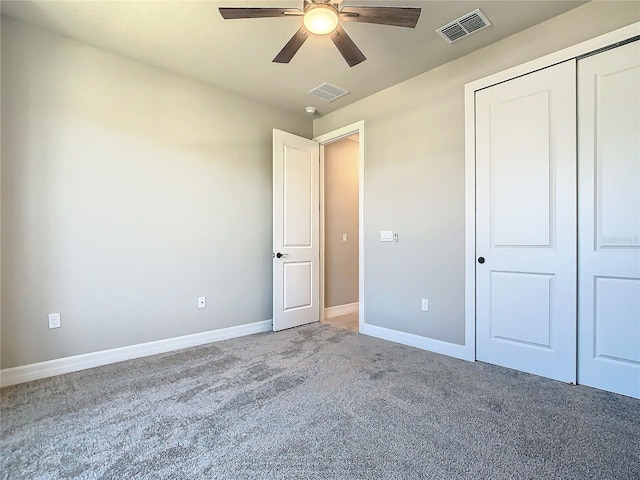 unfurnished bedroom with carpet, ceiling fan, and a closet