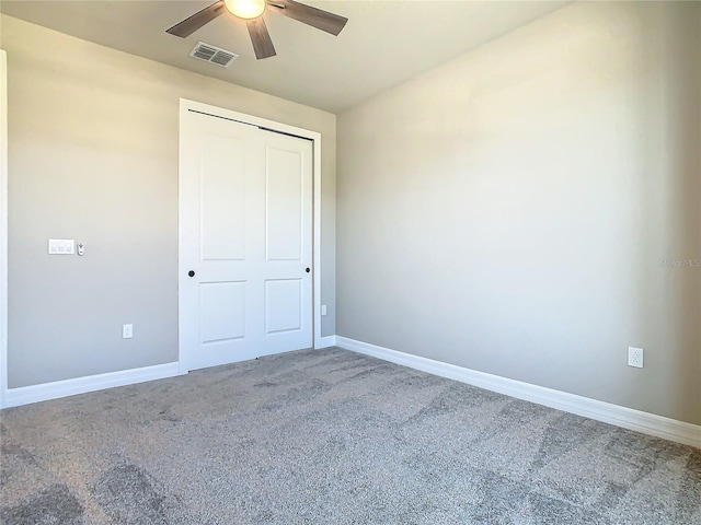 unfurnished bedroom featuring carpet, ceiling fan, and a closet