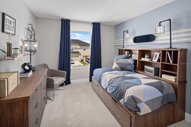 carpeted bedroom with a textured ceiling and baseboards