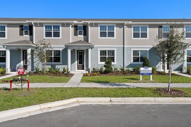 view of property featuring a front yard