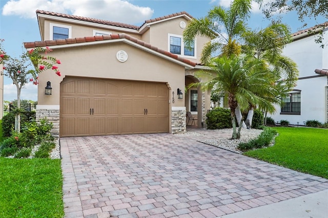 mediterranean / spanish-style house featuring a garage and a front yard