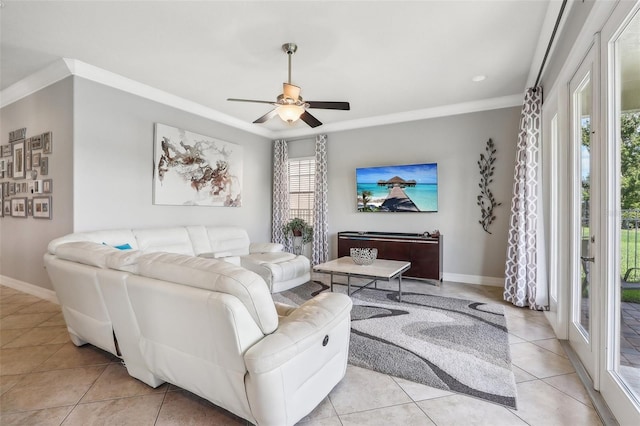 living room featuring ceiling fan, ornamental molding, light tile patterned floors, and a wealth of natural light