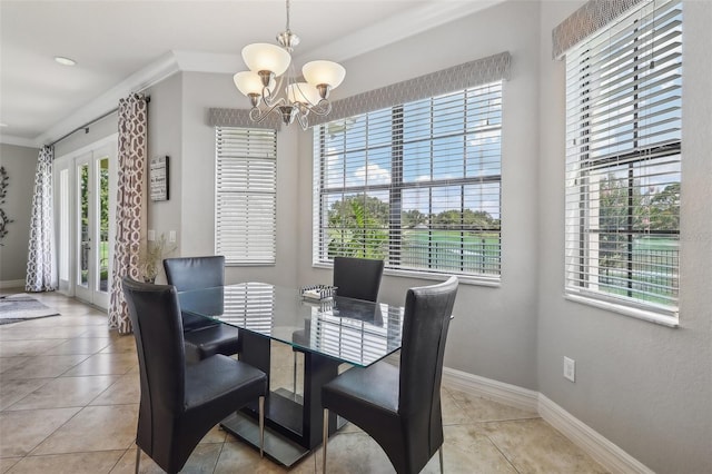 tiled dining area with crown molding, a healthy amount of sunlight, and a chandelier