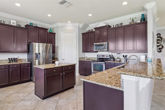 kitchen with sink, appliances with stainless steel finishes, light stone countertops, a kitchen island, and kitchen peninsula