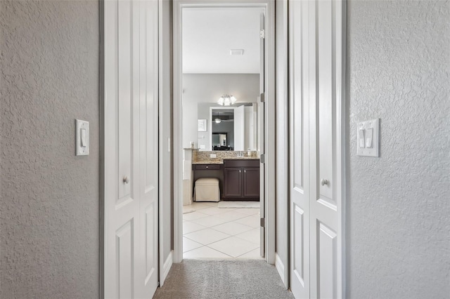 corridor with light tile patterned flooring