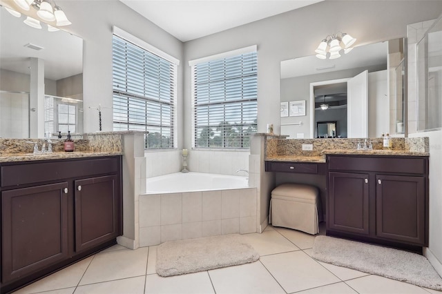 bathroom featuring tile patterned flooring, shower with separate bathtub, and vanity