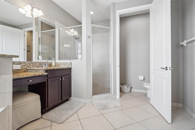 bathroom featuring vanity, tile patterned floors, a shower with door, and toilet