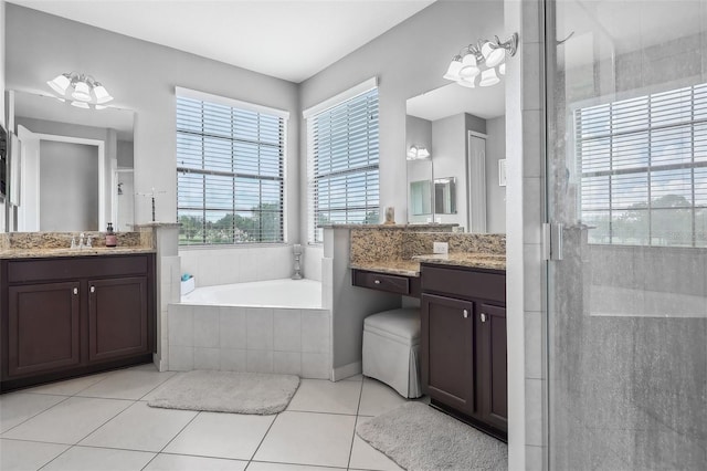 bathroom featuring plus walk in shower, tile patterned floors, and vanity