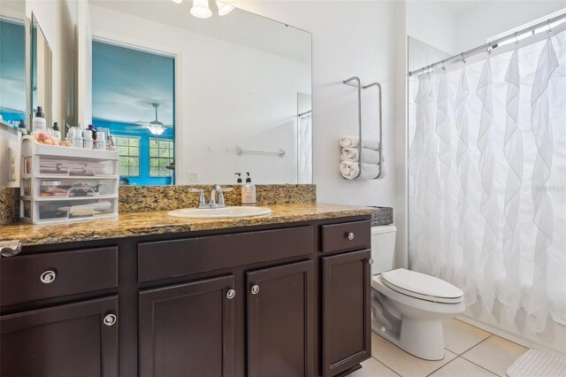 full bathroom featuring tile patterned flooring, vanity, toilet, and shower / tub combo with curtain