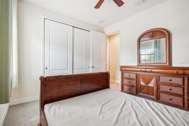 carpeted bedroom with a closet and ceiling fan