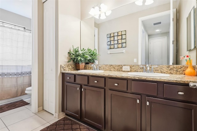 bathroom featuring curtained shower, vanity, toilet, tile patterned floors, and an inviting chandelier