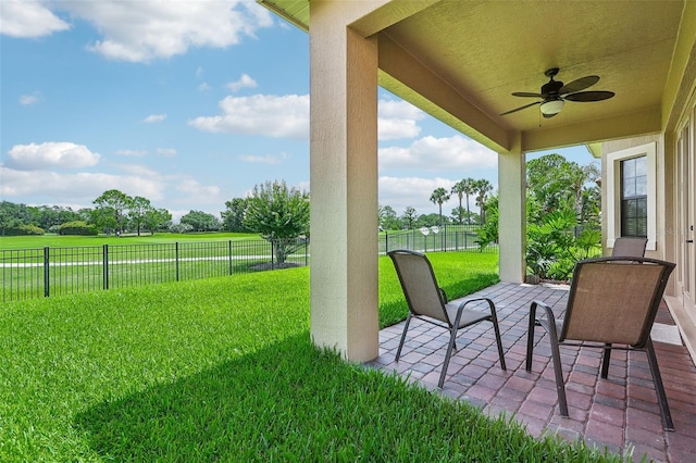 view of yard with a patio and ceiling fan