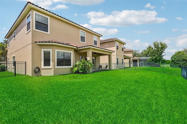 rear view of house featuring a lawn