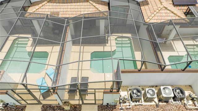 view of side of property featuring glass enclosure