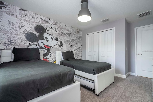 bedroom featuring a closet and light colored carpet