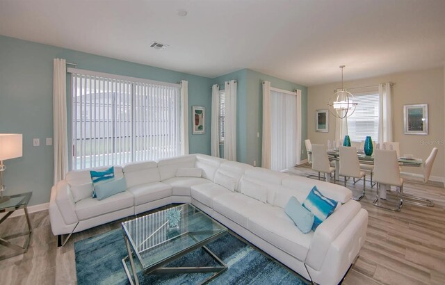 living room with a chandelier and hardwood / wood-style flooring