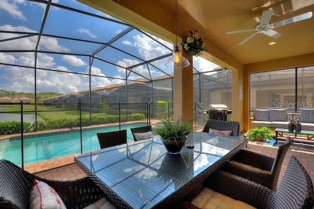 sunroom / solarium featuring ceiling fan