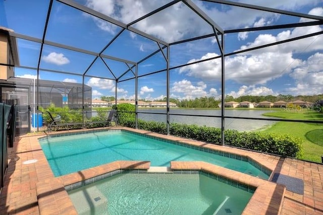 view of pool with a lanai and an in ground hot tub